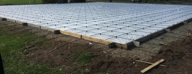 Post-tension cables laid out on chairs over a vapour barrier, formed and ready to pour